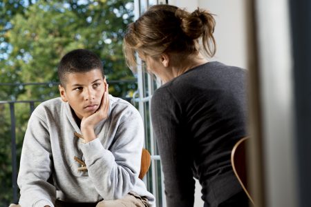 Mixed Race Teenager Talking To Counsellor or Teacher
